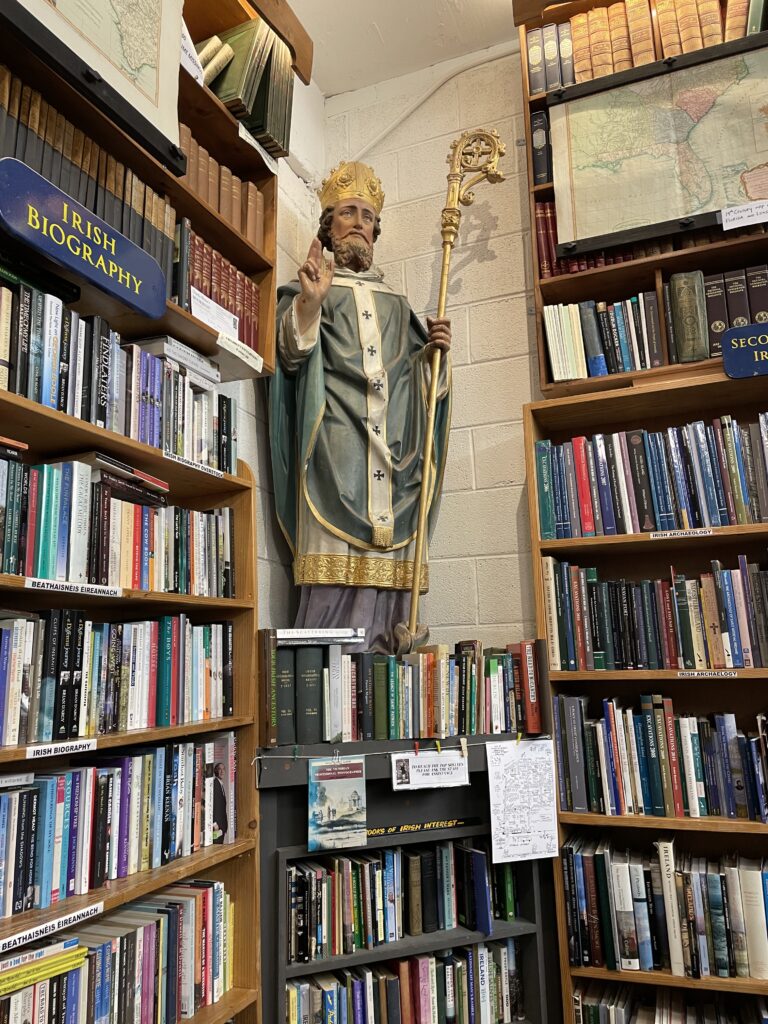 statue of Saint Patrick between two large bookcases